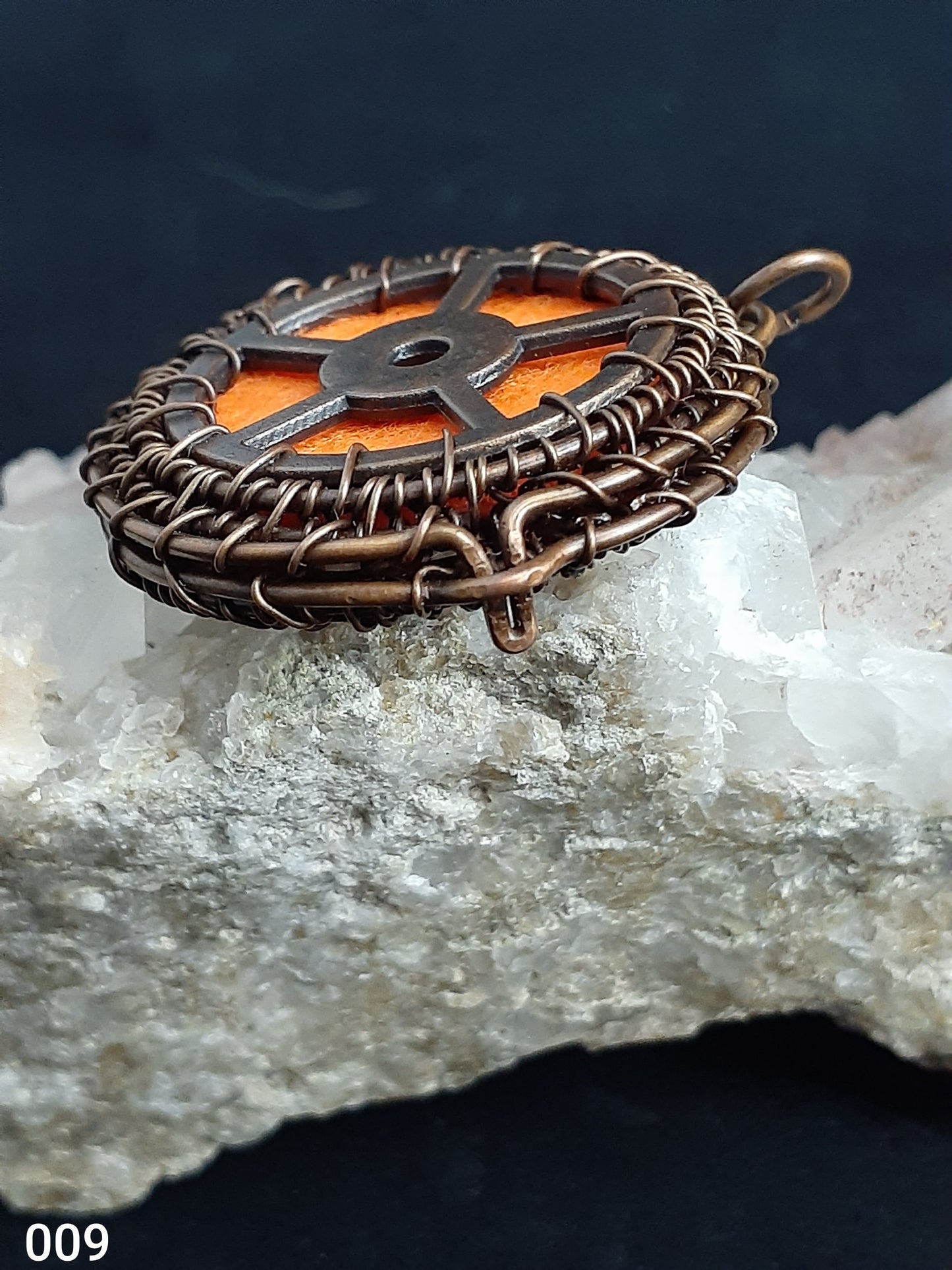 Wired Wrapped Essential Oil Locket Necklace  Artist: Lindsey Griffin  Wired Wrapped Essential Oil Locket Necklace   1 7/16" long x&nbsp; 1 7/16" wide   Extra Felt pads for other Oils and&nbsp; Copper Wire Wrapped   Nice necklace piece for any neckline   Please note Items are handmade by Artist