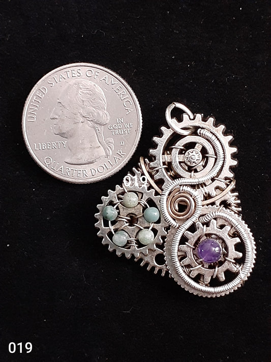 Silver Steampunk-gears Necklace Artist: Lindsey Griffin Wired Wrapped Amethyst/Indian Agate Beads 1 5/16" long x  1 1/4" wide  Silver Filed Wire  Nice necklace piece for any neckline  Please note Items are handmade