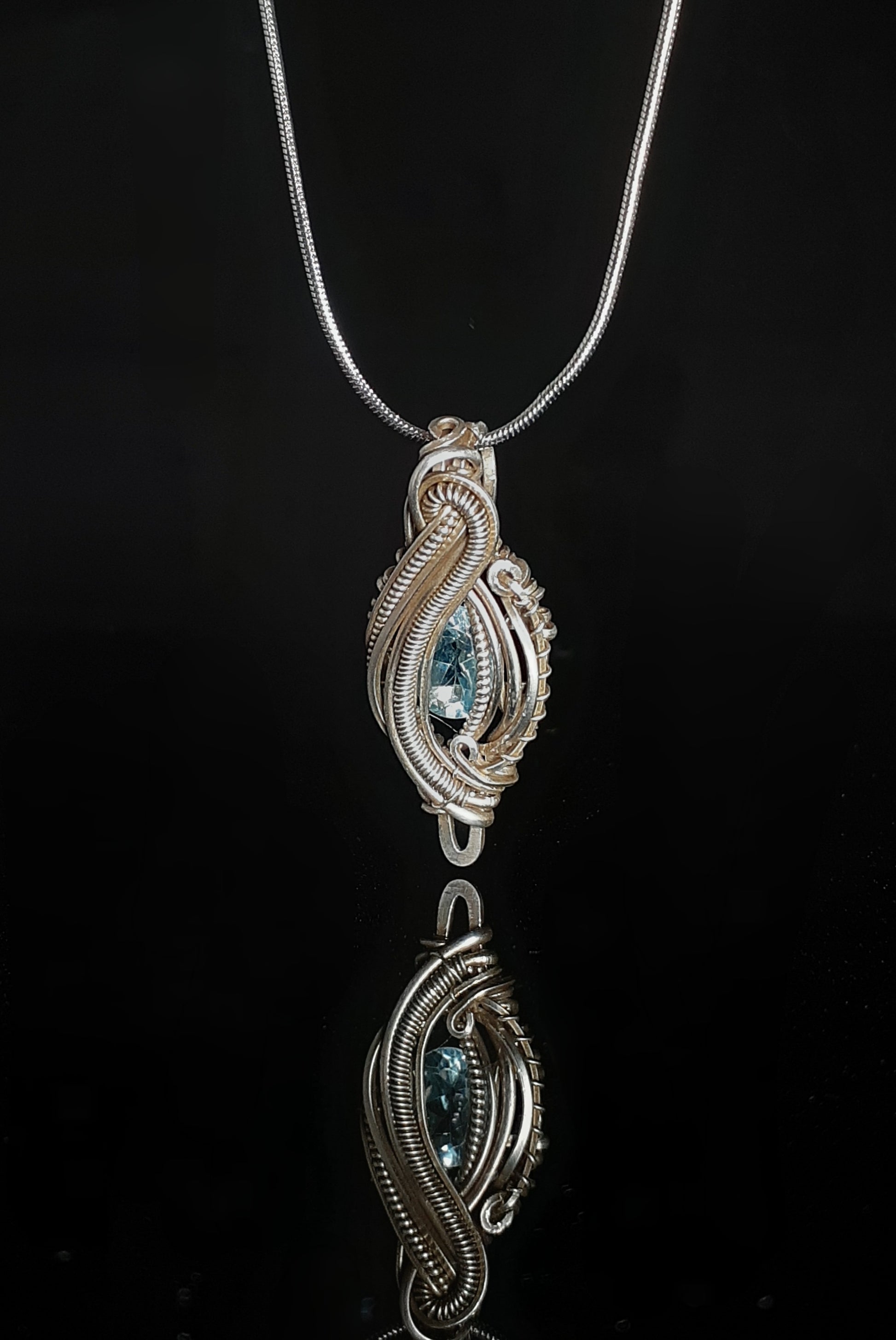 Blue Topaz Sterling Silver Micro Heady Pendent Artist: Lindsey Griffin  Blue topaz stone set in sterling silver micro heady style pendent necklace