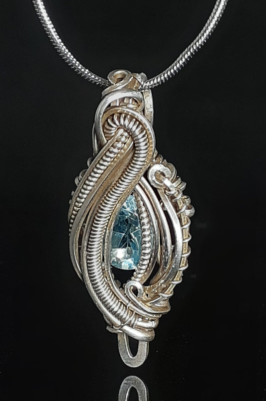 Blue Topaz Sterling Silver Micro Heady Pendent Artist: Lindsey Griffin Blue topaz stone set in sterling silver micro heady style pendent necklace  Silver snake chain for around the neck  1 1/2 Long x 9/16 Wide x 1/4 Deep  A beautiful delicate necklace / pendent  to wear for every day 