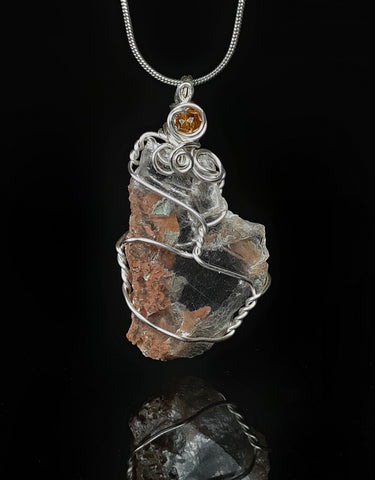 raw selenite crystal found by the artist. wrapped in silver colored artistic wire to be worn as a necklace