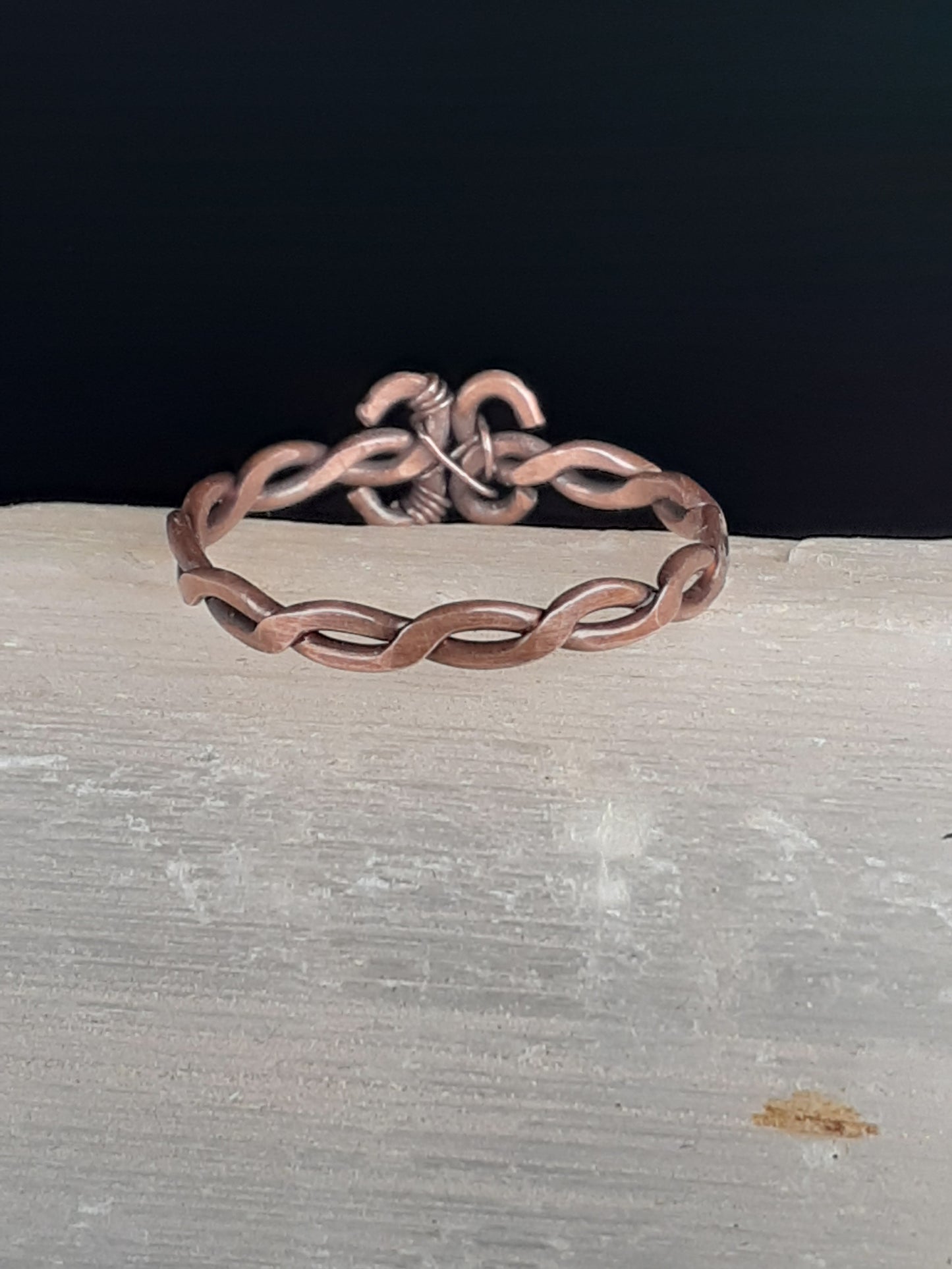 Hammered Copper Stackable Ring Artist: Lindsey Griffin  Hammered oxidized and polished copper wire  Woven wire  Size 7.5  Comes with a polishing cloth and care instructions  Please note items are hand made and there will be variations between each piece Making a stackable ring
