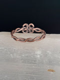 Hammered Copper Stackable Ring Artist: Lindsey Griffin  Hammered oxidized and polished copper wire  Woven wire  Size 7.5  Comes with a polishing cloth and care instructions  Please note items are hand made and there will be variations between each piece Making a stackable ring