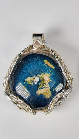 Flat Metal alloy and glass pendant of Planet Earth  Wrapped in silver colored artistic wire