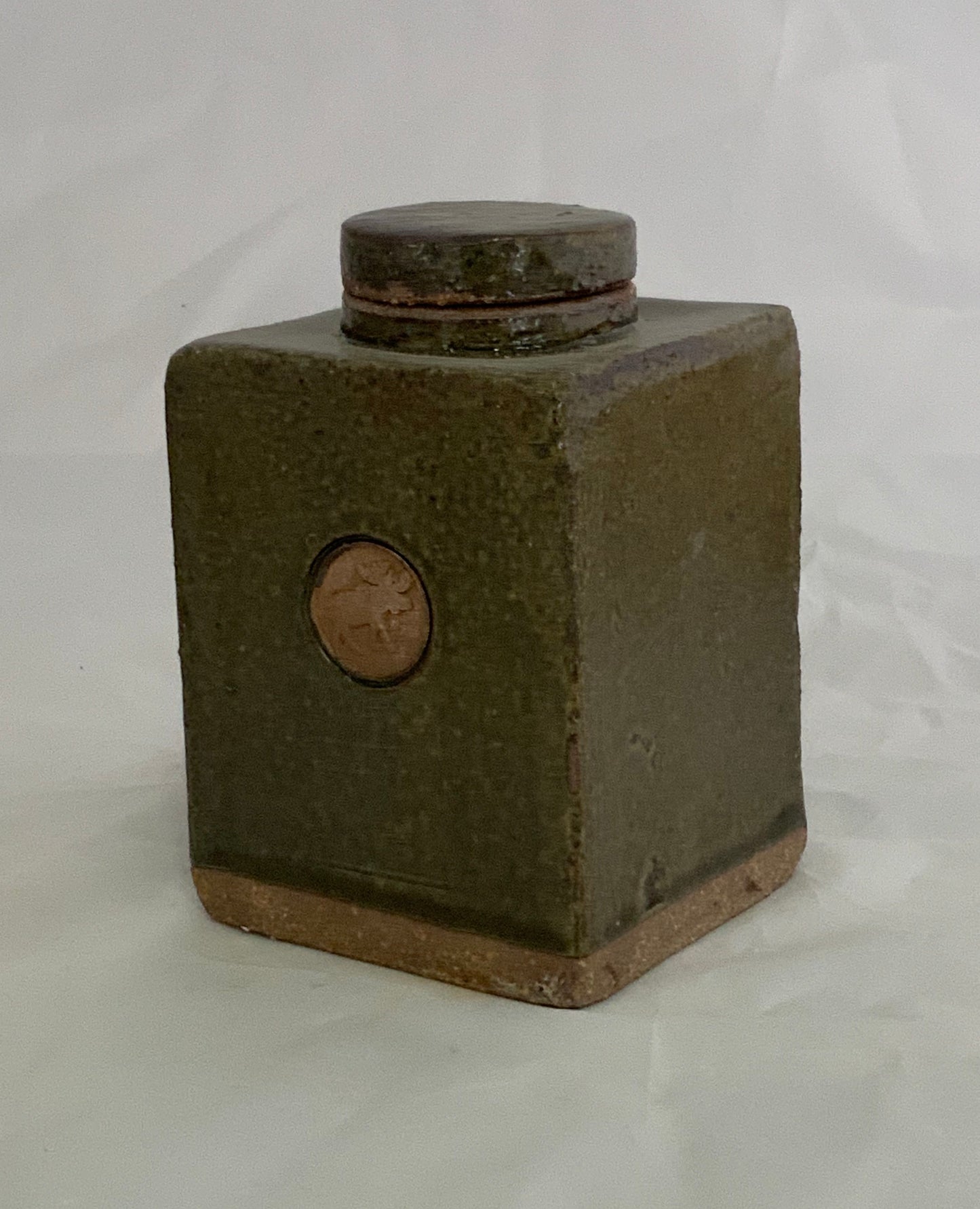 Small Ceramic Green w/Moose Stamp Stoneware Jar Muffy Moore: Ceramic Potter Green w/Moose Stamp Jar 3" long x 3" wide x 4.5"  high  "Moss Green" glaze   Stoneware Square Jar  Round stamp on the front