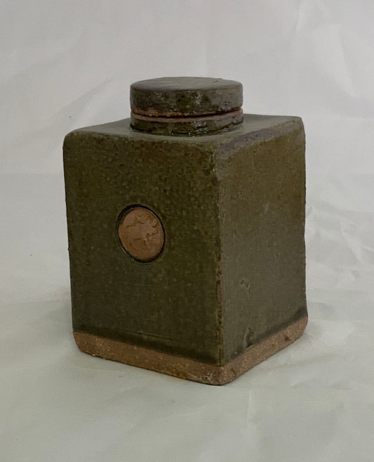 Small Ceramic Green w/Moose Stamp Stoneware Jar Muffy Moore: Ceramic Potter Green w/Moose Stamp Jar 3" long x 3" wide x 4.5"  high  "Moss Green" glaze   Stoneware Square Jar  Round stamp on the front