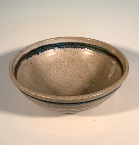 tan bowl with blue / green stripe. Would make a great cereal or ice cream bowl