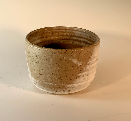 small stoneware bowl with tan and white glaze