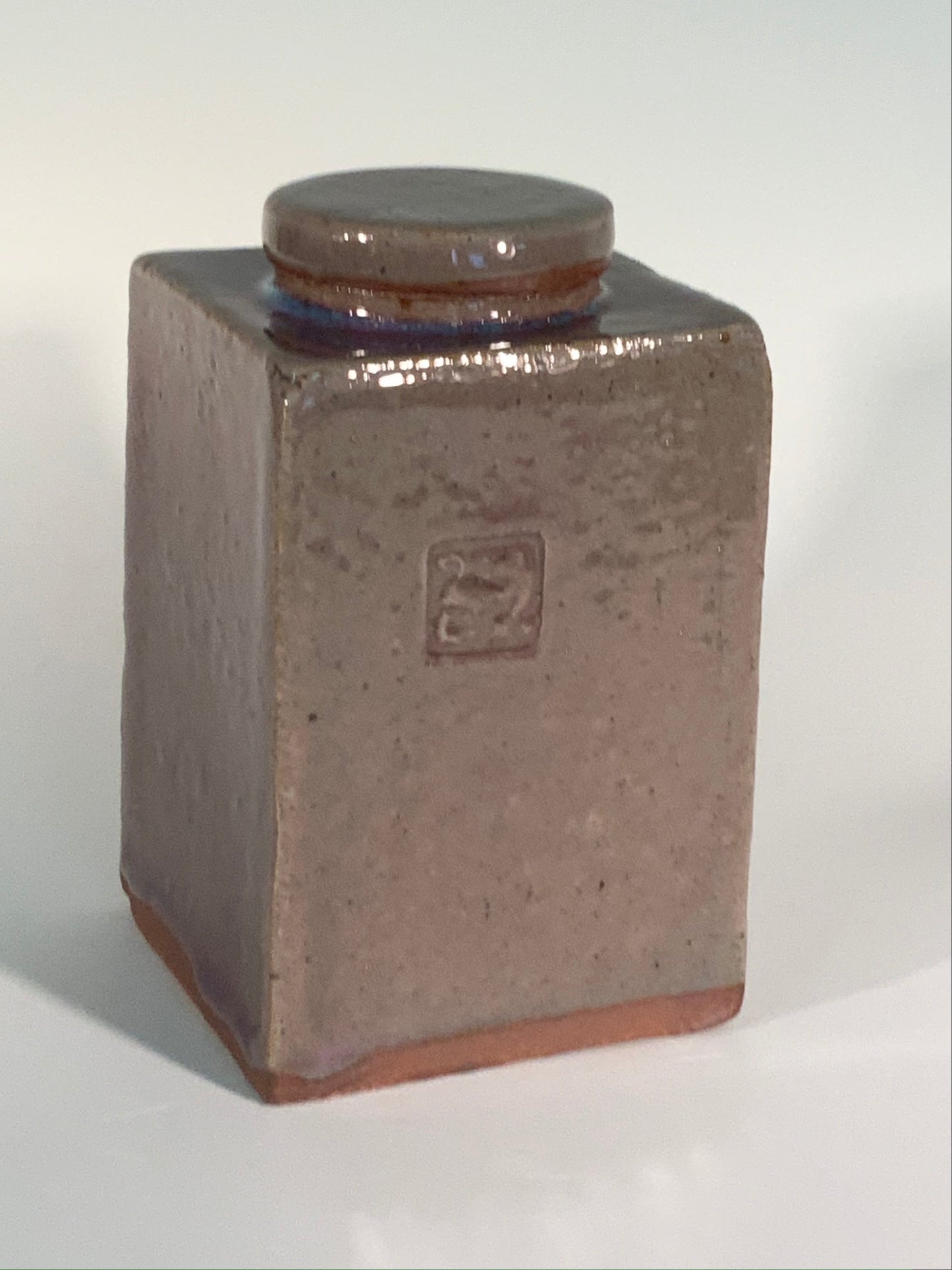 smaller tan and mauve rectangle stoneware jar with lid