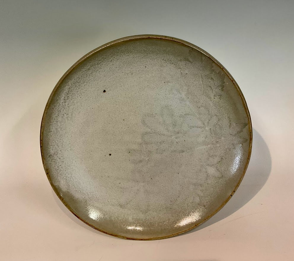 White Winter Leaves 11"  Stoneware Plate - White Winter Leaves 11" Stoneware Plate Muffy Moore: Ceramic Potter Hand thrown stoneware plate  Gray glaze with white winter leaves  11" across x 1 1/2" tall  Will make a large dinner plate or smaller platter