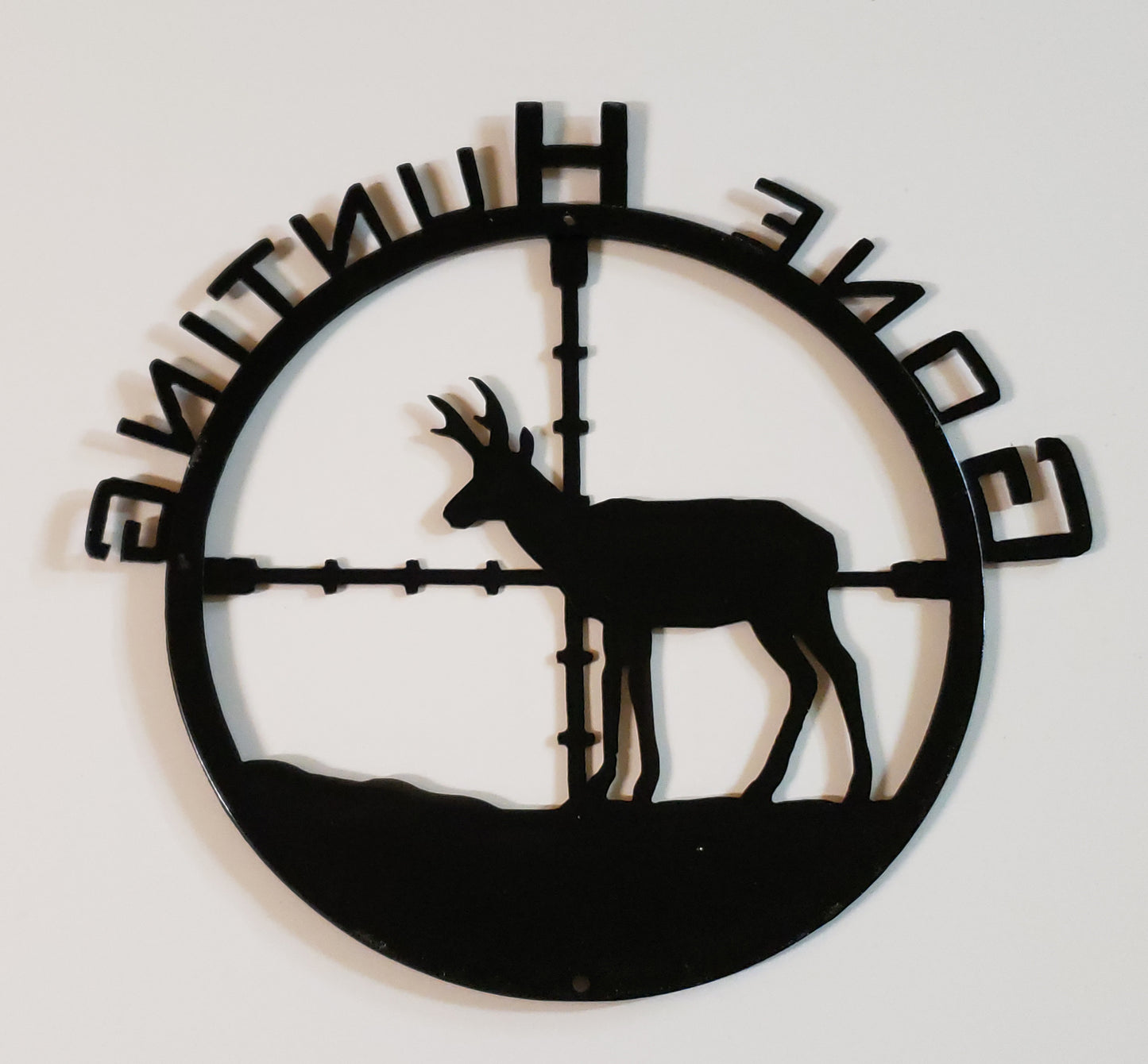 Show the back of the pronghorn metal sign with hold placement for hanging at top and bottom.