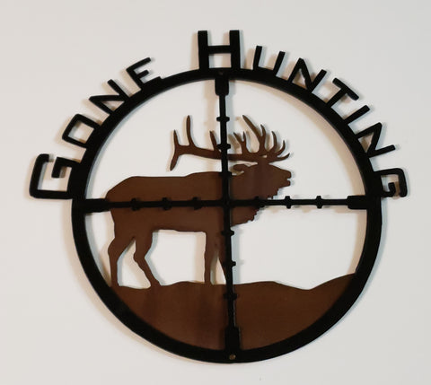 Gone Hunting, Metal sculpture of a bull  elk in the cross hairs of a scope with the works Gone Hunting  wrapped around the top, as if a clock from 9 o clock to 3 o clock positing. Layered sign with black painted scope sight in front layer and back layer sandblasted rustic patina finish with silhouette cutout of Bull Elk. Clear coat enamel protective finish.