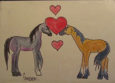 pen and watercolor original. gray mustang and buckskin mustang almost touching noses in front of three hearts. 5" x 7" black plastic frame