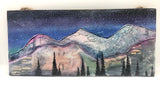  " Smokey Mountain " Wood Plank Original Painting Artist: Nancy Marlatt    Original hand painted watercolor painting with acrylic pen on a wood panel.  The back has felt corners  The back is white washed  Jute string is attached on the backside for wall display  Sealed with an acrylic Satin finish  12" long x 5 1/4" high x 1/4" wide  Find the hidden wildlife animals in the mountain range  Look closely to find Smokey Bears head and Forest Service Hat hiding in the trees