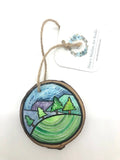 " Hill Side " Hand Painted Wooden Ornament Artist: Nancy Marlatt  Hand painted natural wood slice with a jute string attached  Original watercolor painting  Actual size and weight varies per piece