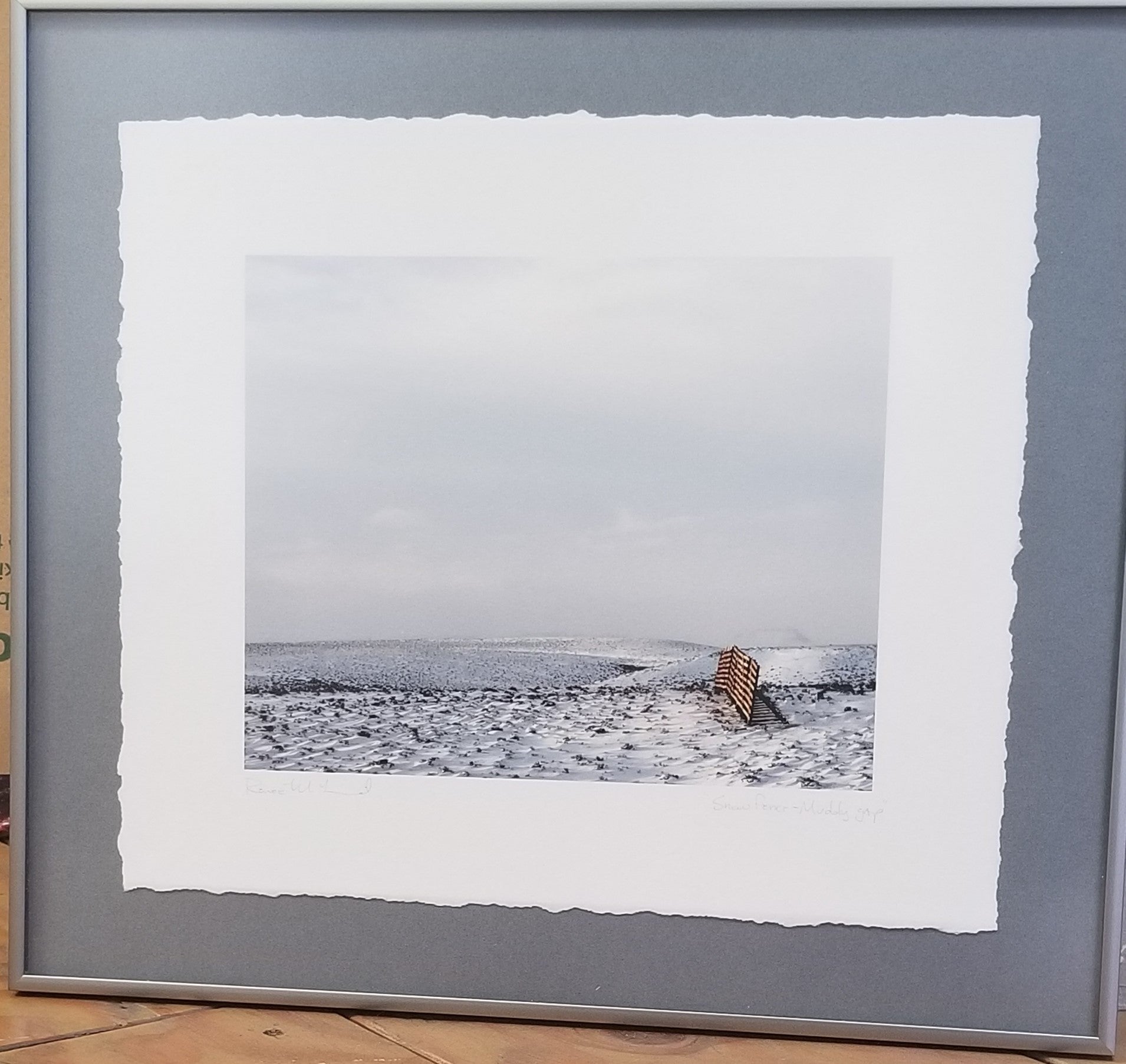 framed photo of a snow fence near Muddy Gap in Wyoming during the winter