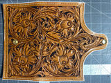 Hand tooled daffodil leather clutch. red and white interior leather. white dyed edged. snap closure. bill pockets and 5 card slots.
