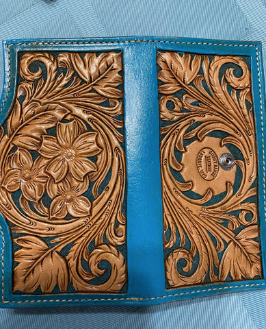 teal dyed leather clutch. snap closure, 5 card slots and 2 bill pockets. 3 flower desing