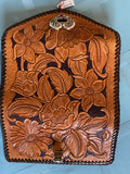 hand tooled floral pattern ladies leather clutch. Metal heart clasp