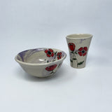 A special gift for your special someone! Choose a handthrown, handpainted bowl and tumbler to enjoy your next meal. Bright red poppy flowers against a purple wash background.