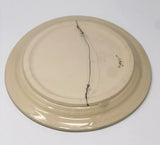 wire has been threaded through the small holes that are in the back of the porcelain platter