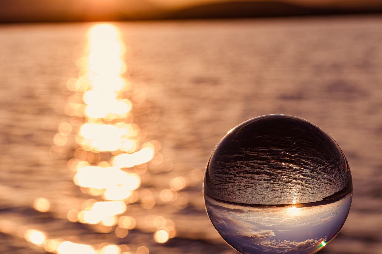 Sunset on the plains lakes outside of Laramie Wyoming shot through a glass orb  10" long x 8" high x 1/2" wide  Metal print  Ready to hang  A very unique perspective of the sunset and water