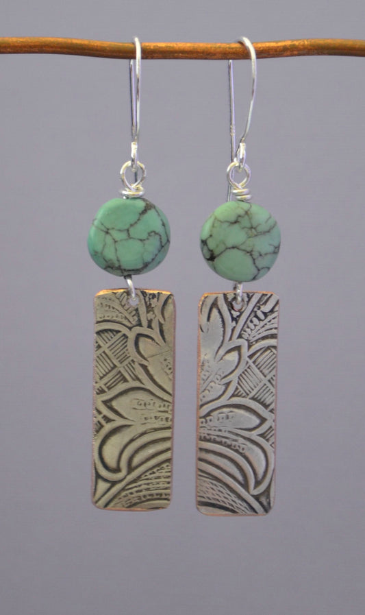 Turquoise Pillows Embossed Silver Plated Earring Artist: Terry Kreuzer   2" Long x 3/8" wide x 1/16" Deep  Sterling Silver ear wires  Please note, the jewelry is custom designed by the Artist , with a slight variation between each piece