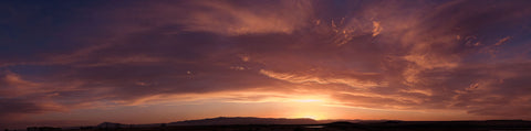 Looking West outside of Laramie Wyoming while the setting sun sets the sky into a beautiful color and the mountains are ready for the night  36" long x 12" high x 1/2" wide  Panoramic Metal print  Ready to hang  Would look great in any room of your home