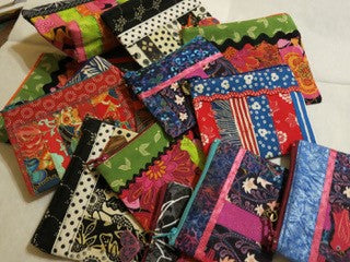 Small Four Inch Quilted Coin Purse Artist: Glenda Haley Quilted and Embellished coin purse  Hand sewn  Zipper top with variety of charms  Various pattern material and   Please note items are hand made and there is a variety between pieces  JLO