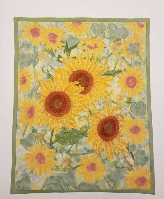 Layers of Sunshine, fiber art wall hanging by Crystal Lawrence. Hand dyes, hand embellished with embroidery stitches. Beautiful sunflowers to enjoy year round.