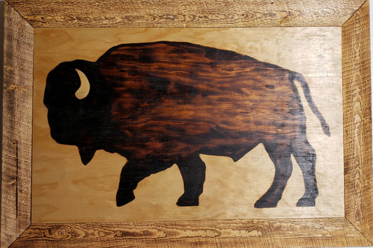 Bison Wood Burned Wall Hanging Artist: Michael McMahon 38" long x 26" high x 1" wide  D-Ring and wire for hanging  Natural wood color  Sanded plywood base with buffalo shape burned using various temperatures to achieve different shades of brown and black  Horn coated with thick layers of clear polyurethane to give color and depth  Frame is rough cut lumber lightly burned to give toasted brown color  Coated in protective polyurethane  This would be a perfect lodge, cabin or office wall decoration.