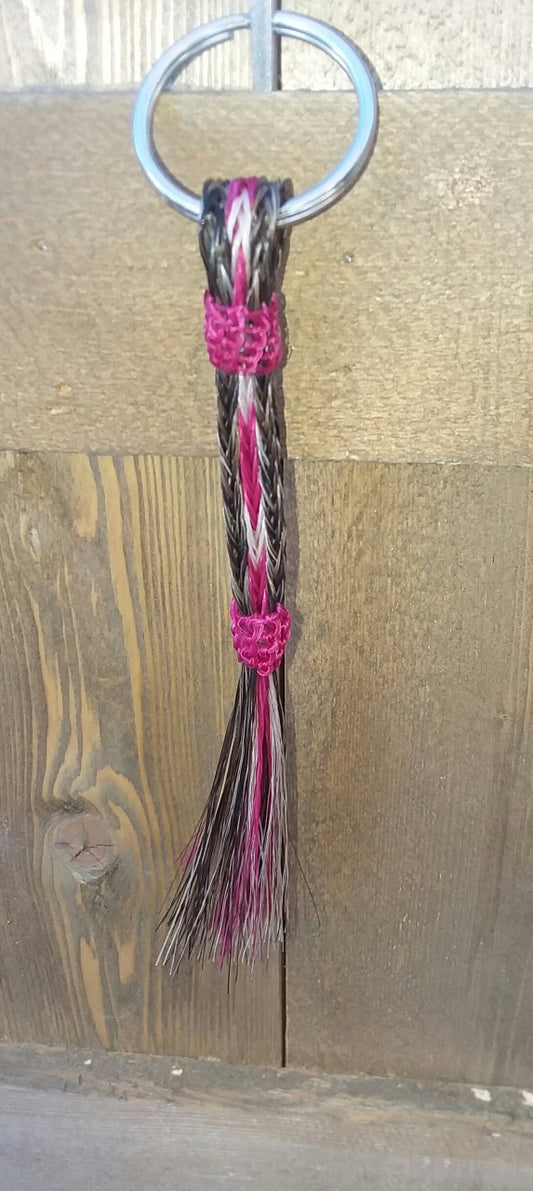 hand braided horsehair keychain in dark color with pink and white