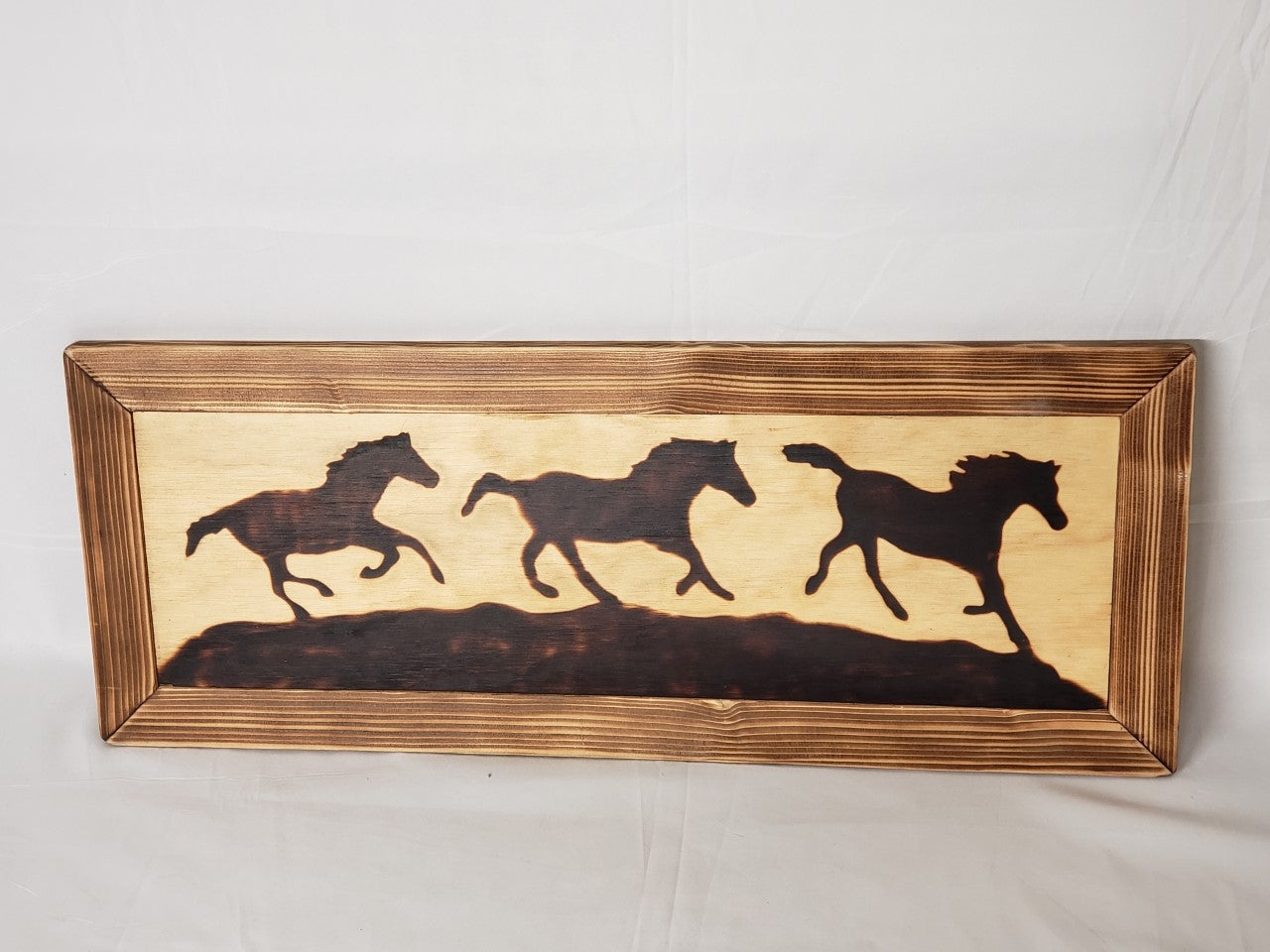 Wood Burned Horses In Wooden Frame. Silhouette of three horses running on a hill. wall hanging