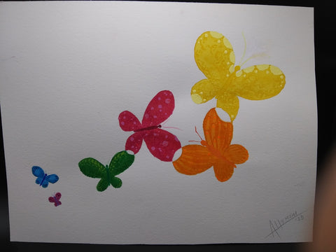 Original watercolor painting of butterflies in colors of the rainbow  Framed in a white wooden frame  Brown kraft paper covers the back of the piece  11" long x 13" wide x .5" high  Eye bolt and wire on the back for hanging