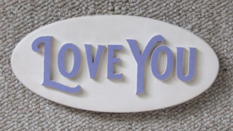 Wooden oval sign with Hand cut letters spelling Love You. eye bolt and chain for hanging the sign.
