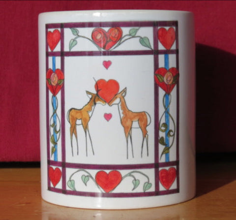8 oz white ceramic mug with handle  Design is from an original drawing by the artist  Two Pronghorn (Antelope) with hearts between them  Maroon boarder with hearts, greenery and roses  4" long x 5 1/2" high blank card with envelope  Great Valentine's Day card for the ones you love  Add a little packet of chocolate kisses and make a perfect Valentine's gift to the one you love