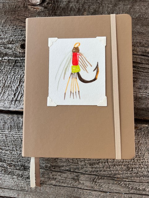 Watercolor  painting of Fishing Fly onTaupe colored leather like cover with elastic page holder.  Dot lined  bullet journal